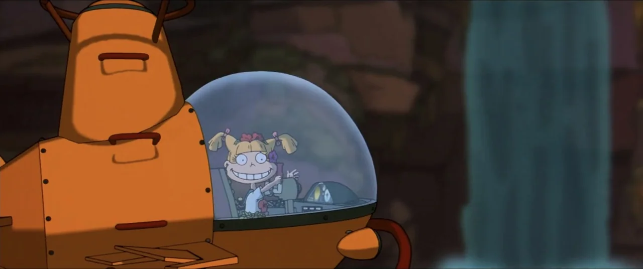 Rugrats Go Wild (2003) movie still: medium — A dense green jungle environment features a small orange metal submarine near a waterfall. A blonde…