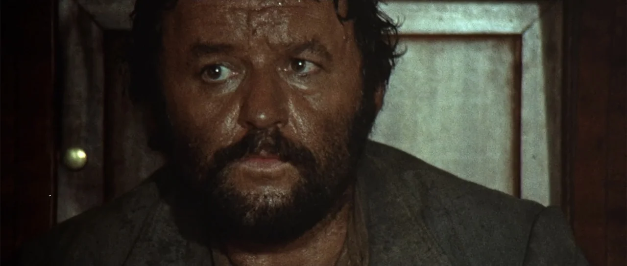 Duck, You Sucker (1971) movie still: closeup — An interior space contains a man viewed in a tight composition. The man displays signs of sweat on…