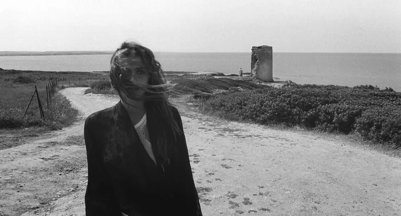 The Legend Of Kaspar Hauser (2012) movie still: medium — A coastal landscape features a dirt path leading past a crumbling stone tower. A young…