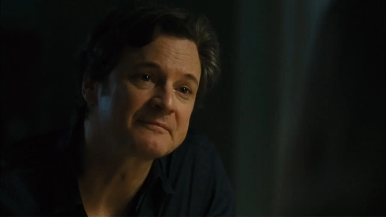 Before I Go to Sleep (2014) movie still: closeup — A dark indoor space with minimal background detail visible in the shadows. A middle-aged man with…