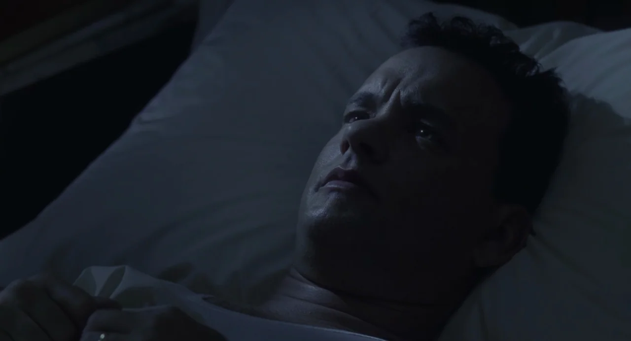 The Green Mile (1999) movie still: closeup — A man lies on a pillow in a dark, dimly lit environment at night. He is positioned on his side and…