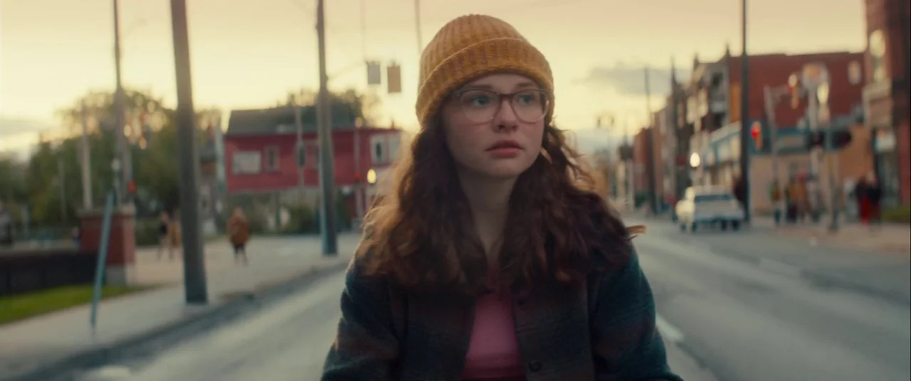 Scary Stories to Tell in the Dark (2019) movie still: medium — A suburban street during the golden hour with buildings lining both sides of the…