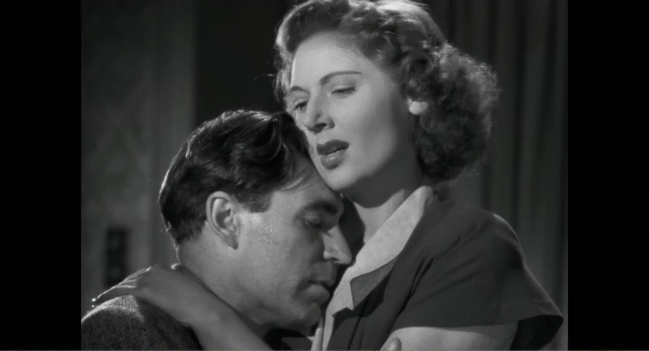 Made in England: The Films of Powell and Pressburger (2024) movie still: medium — A 1940s interior space features two people in an embrace. A woman…