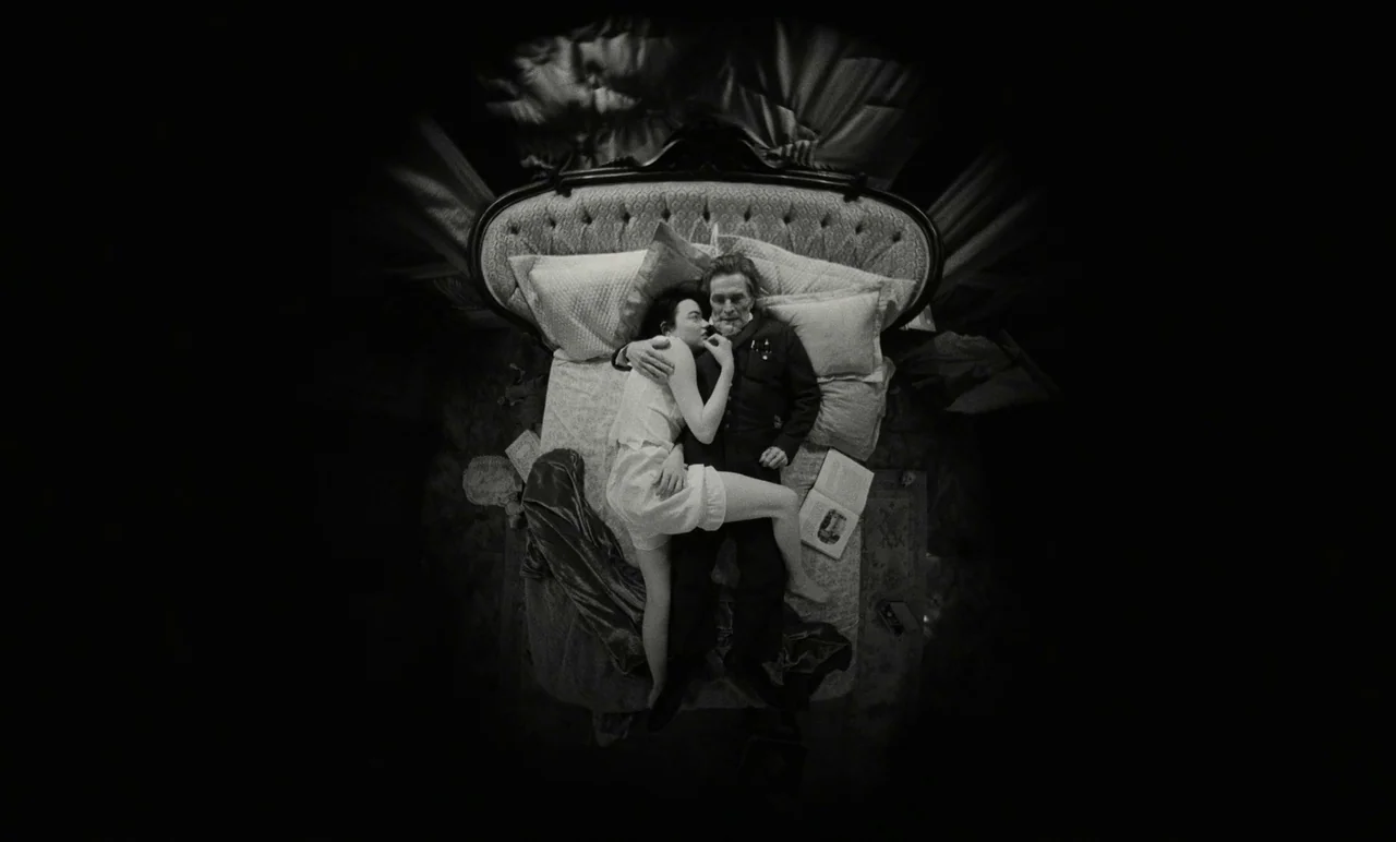 Poor Things (2023) movie still: fullbody — A man and a woman lie together in a large, ornate, high-backed bed. They are centered in the frame…