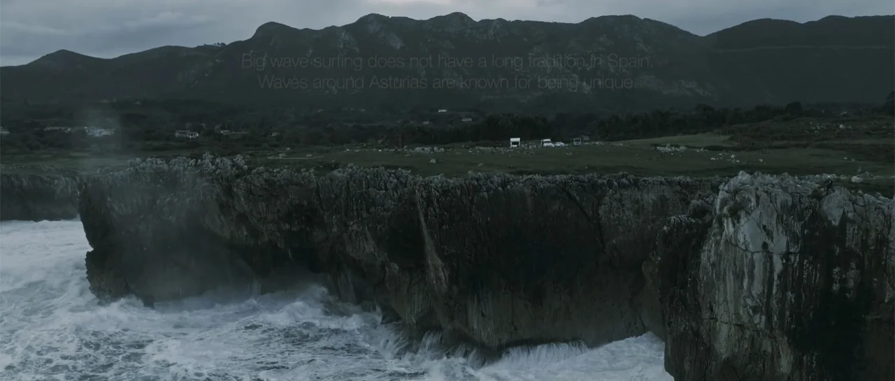 Taking Back the Waves (2017) movie still: establishing — A rugged coastline in Asturias, Spain features sharp cliffs overlooking turbulent crashing…