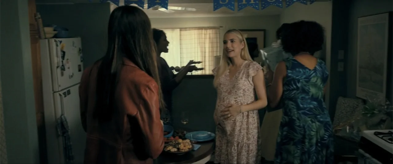 Madame Web (2024) movie still: medium — A residential room decorated for a celebration with paper banners hung near the ceiling. A pregnant woman in…