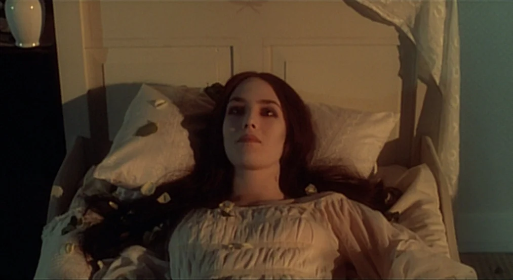 Nosferatu the Vampyre (Nosferatu Phantom Der Nacht) (1979) movie still: medium — A woman lies on a bed with white bedding scattered with small…