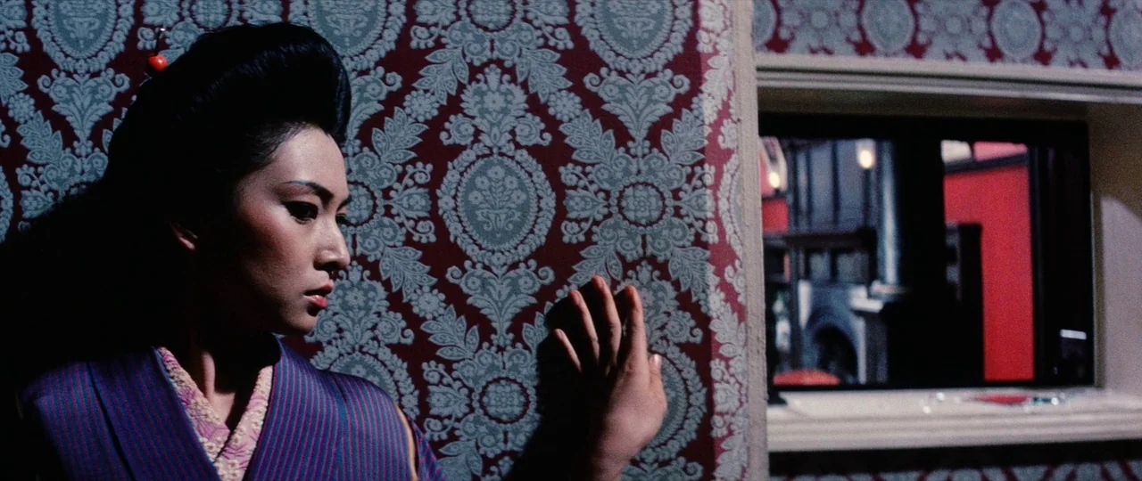 Lady Snowblood Song of Vengeance (1974) movie still: medium — An interior wall covered in dense floral pattern wallpaper meets a window ledge. A…