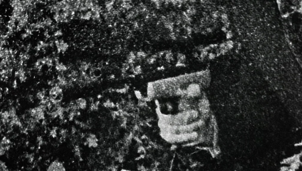 Blow-Up (1966) movie still: closeup — A dark, heavily textured environment obscures all surroundings except for a singular point. A human hand…