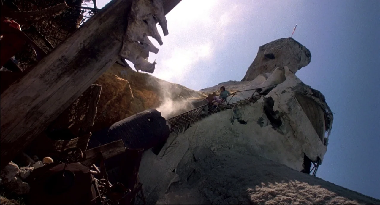 The Texas Chainsaw Massacre 2 (1986) movie still: wide — A massive sculpted rock structure resembles Mount Rushmore partially obscured by debris and…