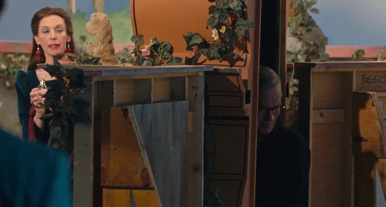 A Beautiful Day In The Neighborhood movie still: medium — A television set decorated with faux ivy and wooden structures painted with orange…