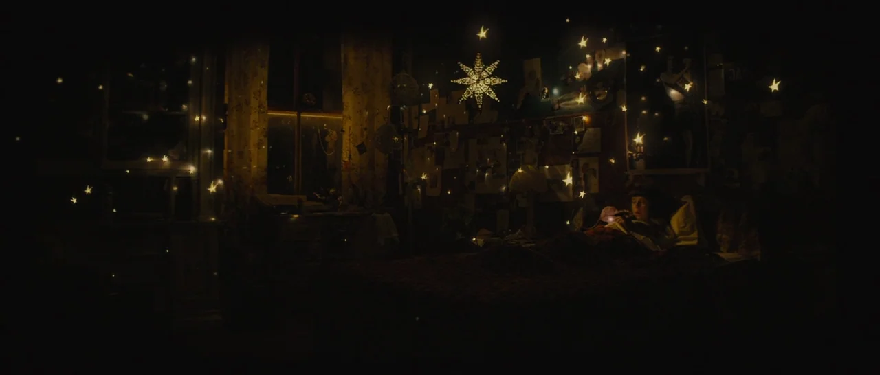 The Diary of a Teenage Girl (2015) movie still: wide — A dimly lit room is filled with numerous floating, star-shaped lanterns and decorations. A…