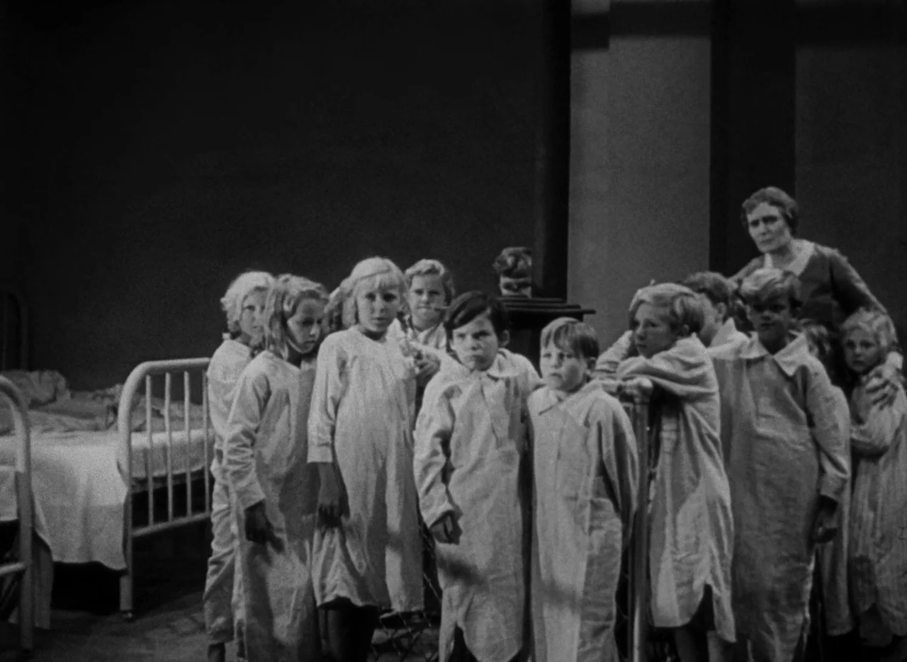 The Invisible Man (1933) (1933) movie still: medium — A dormitory interior filled with metal cots and children in light-colored nightgowns. A group…