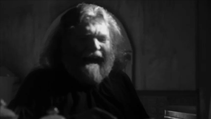 Keyhole (2011) movie still: closeup — A dimly lit stone chamber with rough masonry walls. A middle-aged man yells with his mouth open while in shadow.