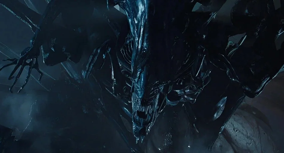 Aliens (1986) movie still: closeup — A dark, cramped interior space is filled with organic, slick alien textures and structures. A large xenomorph…