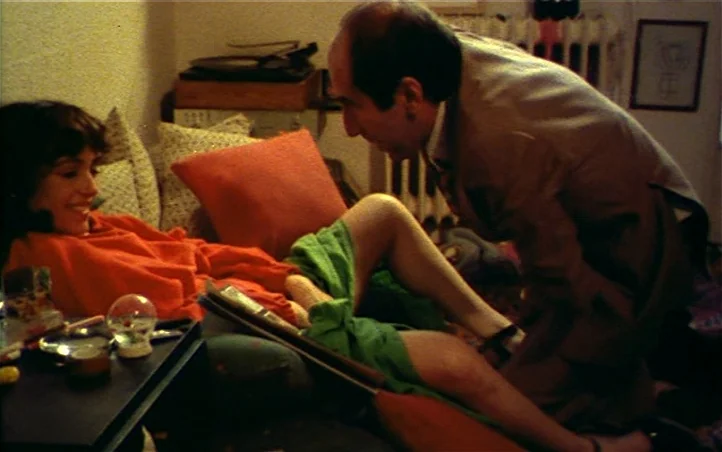 Pepi, Luci, Bom and Other Girls Like Mom (1980) movie still: medium — A dimly lit room contains a bed with textured cushions and a small table. A…