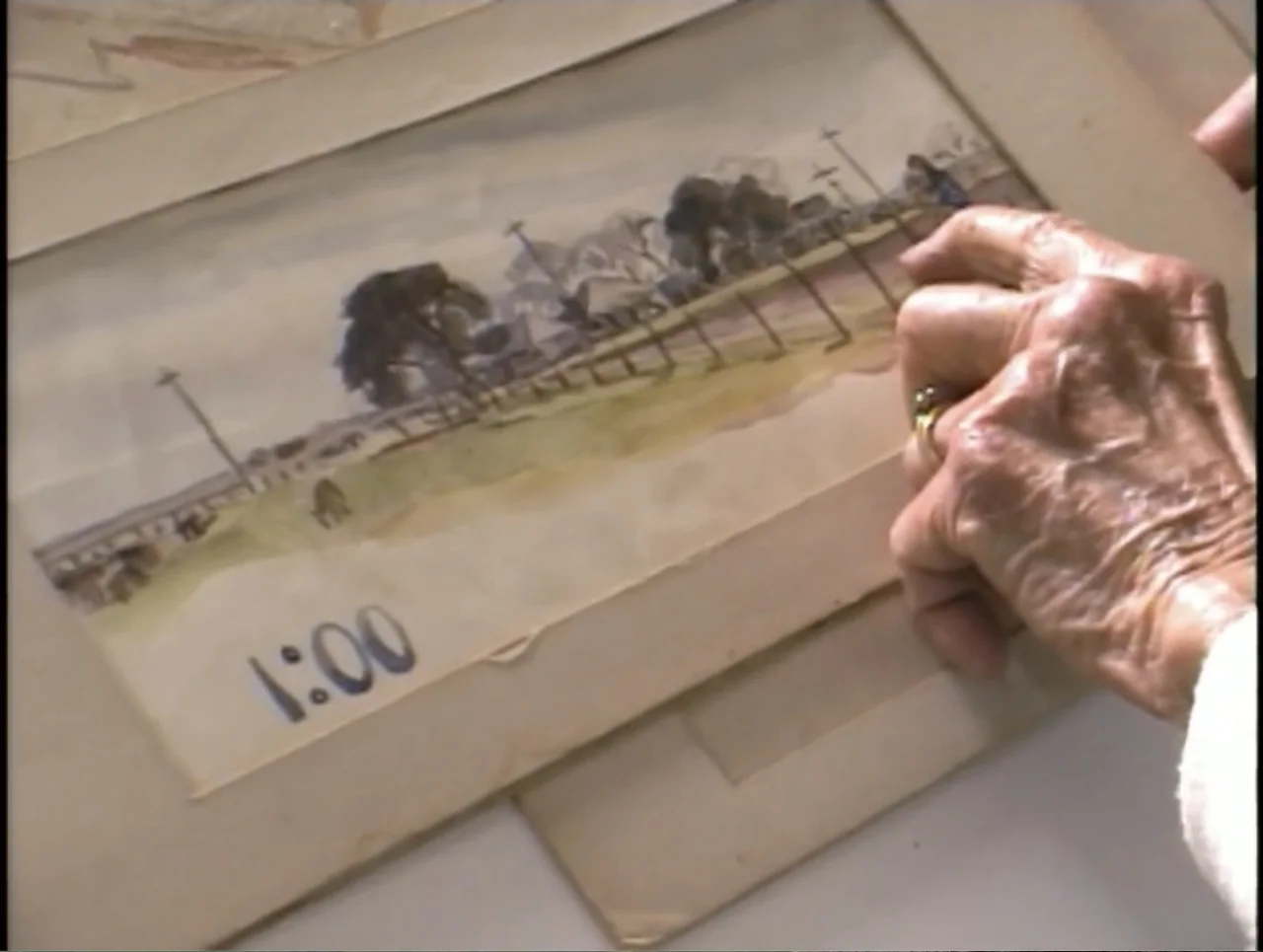 A Rape in a Small Town: The Florence Holway Story (2005) movie still: closeup — An aged hand holds a rectangular piece of paper featuring a…