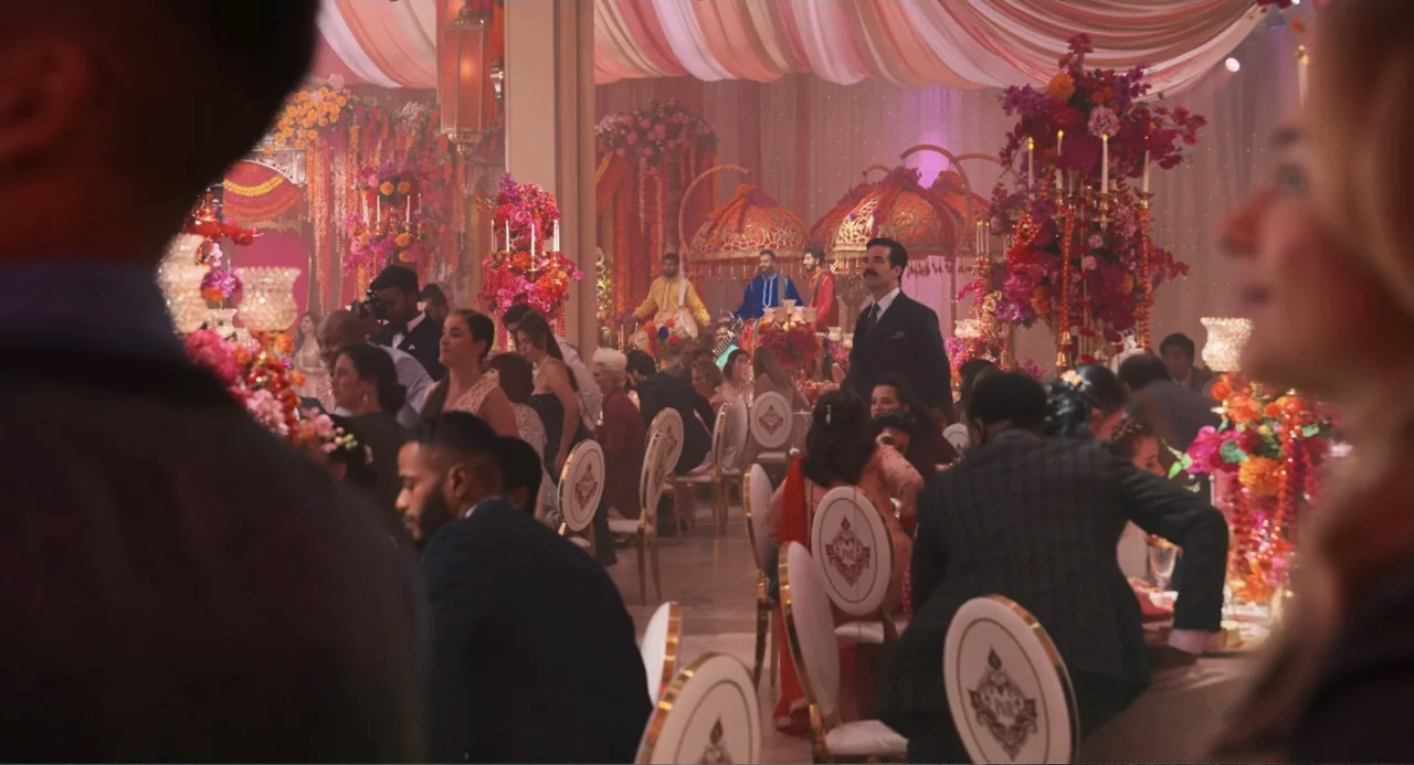 Tom & Jerry (2021) movie still: wide — A spacious banquet hall decorated with hanging fabric and elaborate floral displays for festivities. Guests…