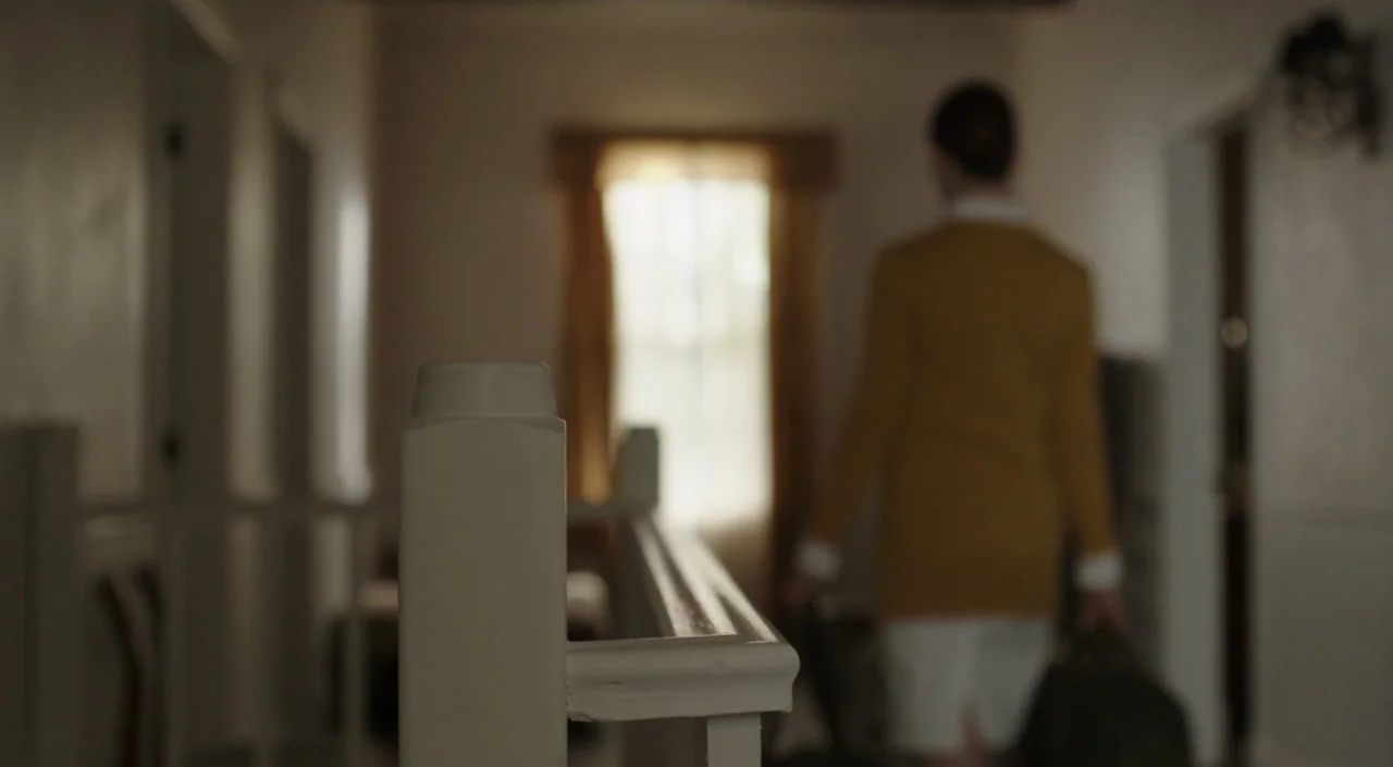 I Am The Pretty Thing That Lives In The House (2016) movie still: medium — A residential hallway with wooden bannisters and a distant window…