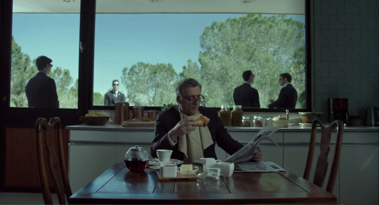 Norman: The Moderate Rise and Tragic Fall of a New York Fixer (2016) movie still: medium — A modern, minimalist kitchen features a large window…
