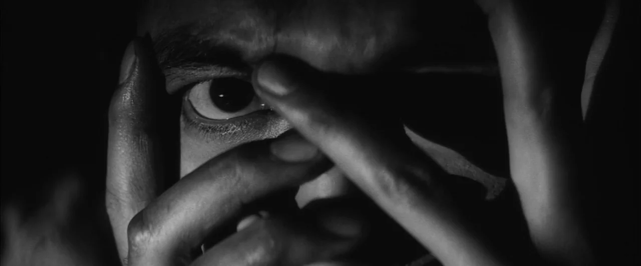 The Human Condition III: A Soldier’s Prayer (1961) movie still: closeup — A dark, undifferentiated space provides the backdrop for a close view of a…
