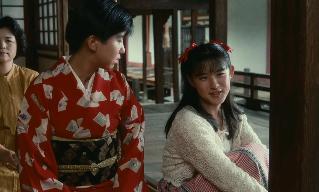Chizuko’s Younger Sister (1991) movie still: medium — A wooden Japanese veranda overlooks an open courtyard with traditional architectural pillars.…
