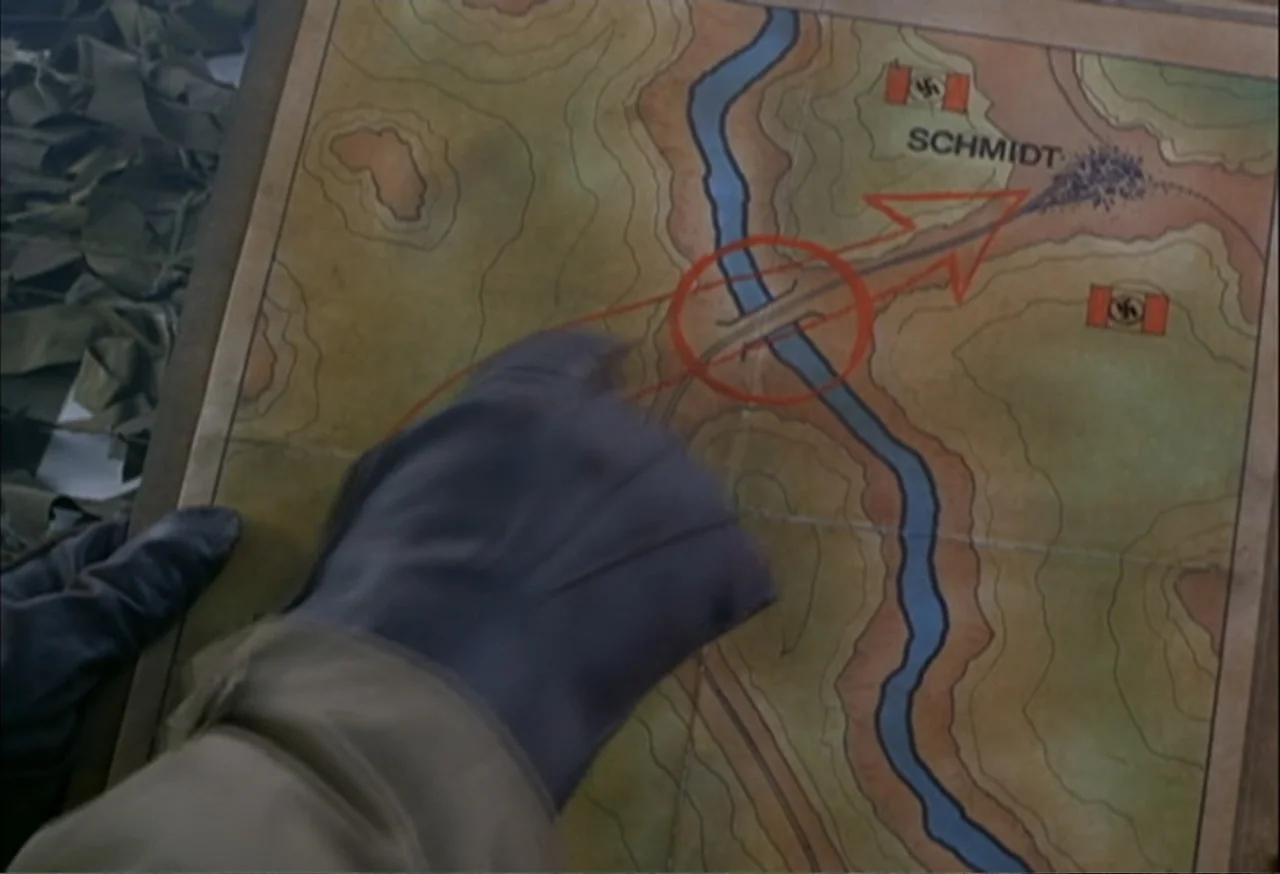 When Trumpets Fade (1998) movie still: closeup — A close-up of a vintage topographical military map printed on aged parchment paper. A gloved hand…