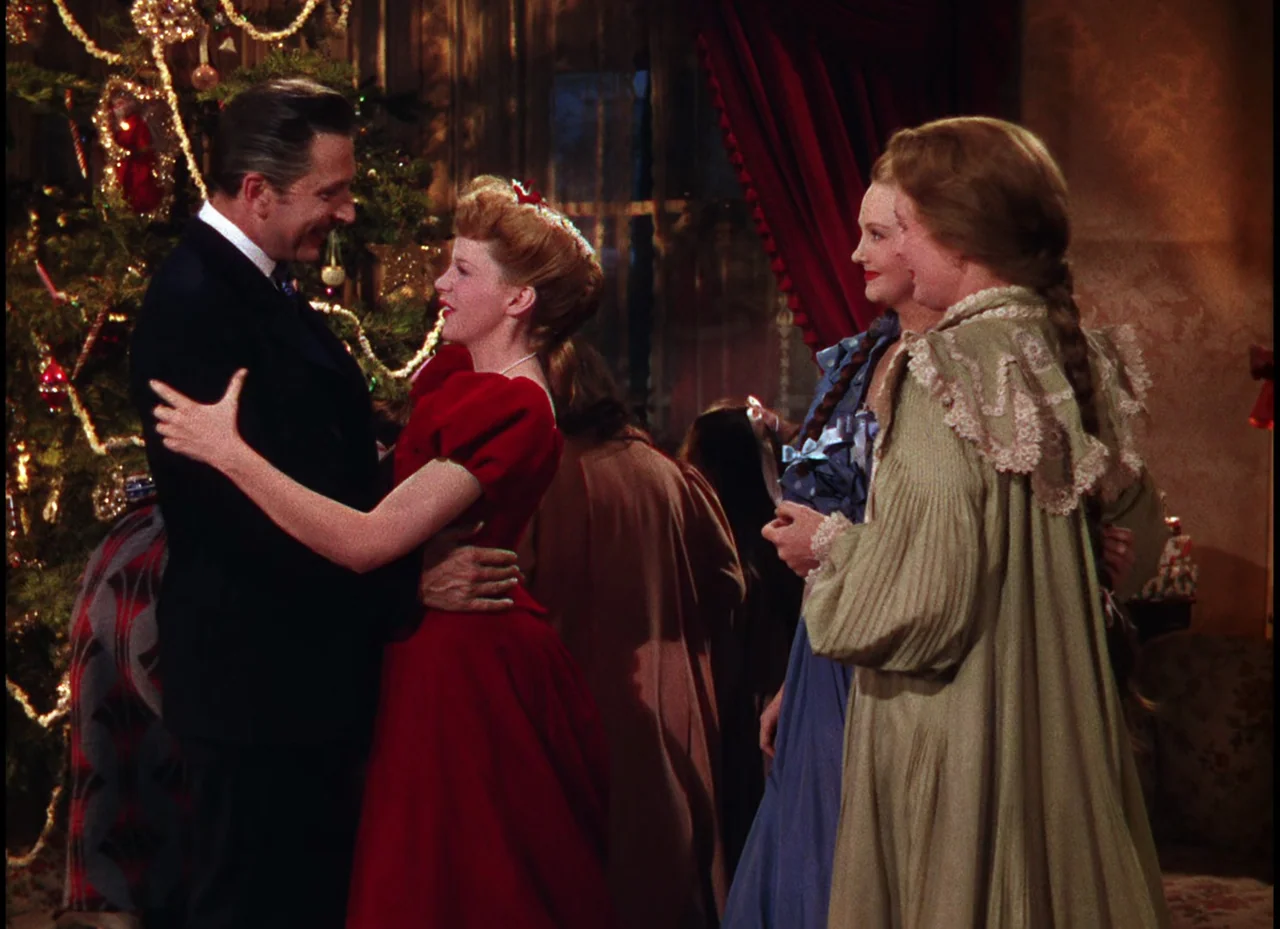 Meet Me In St. Louis (1944) movie still: medium — A festive indoor holiday setting features a decorated evergreen tree with gold ornaments. A man…