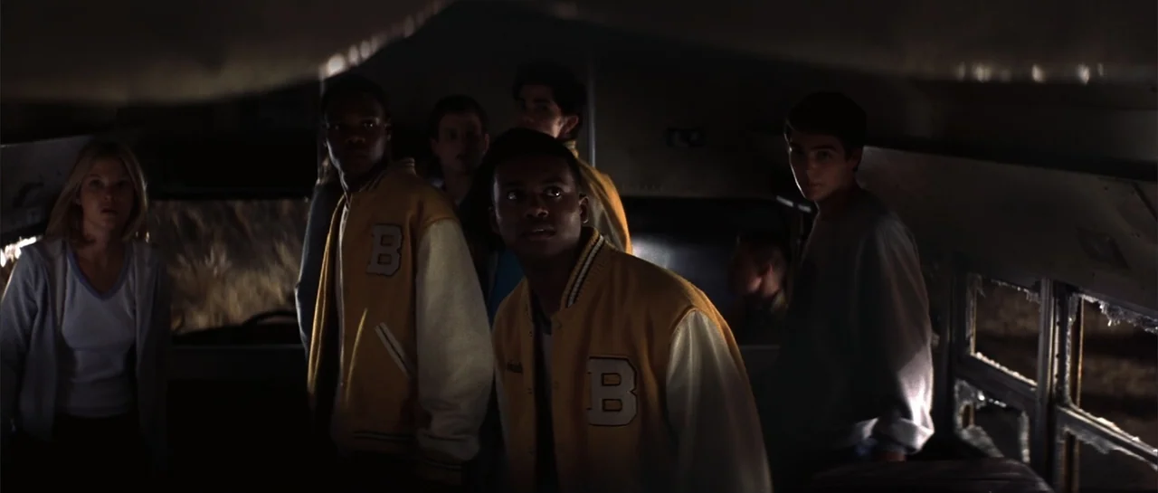 Jeepers Creepers 2 (2003) movie still: medium — The dark interior of a bus contains several teenagers looking out through the front windshield. The…