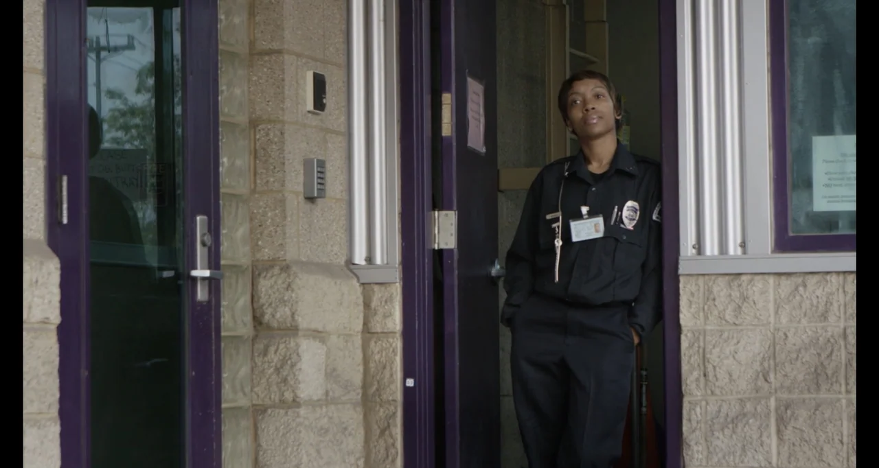 Abortion: Stories Women Tell (2016) movie still: medium — A stone building entrance with dark purple door frames and concrete block walls. A…