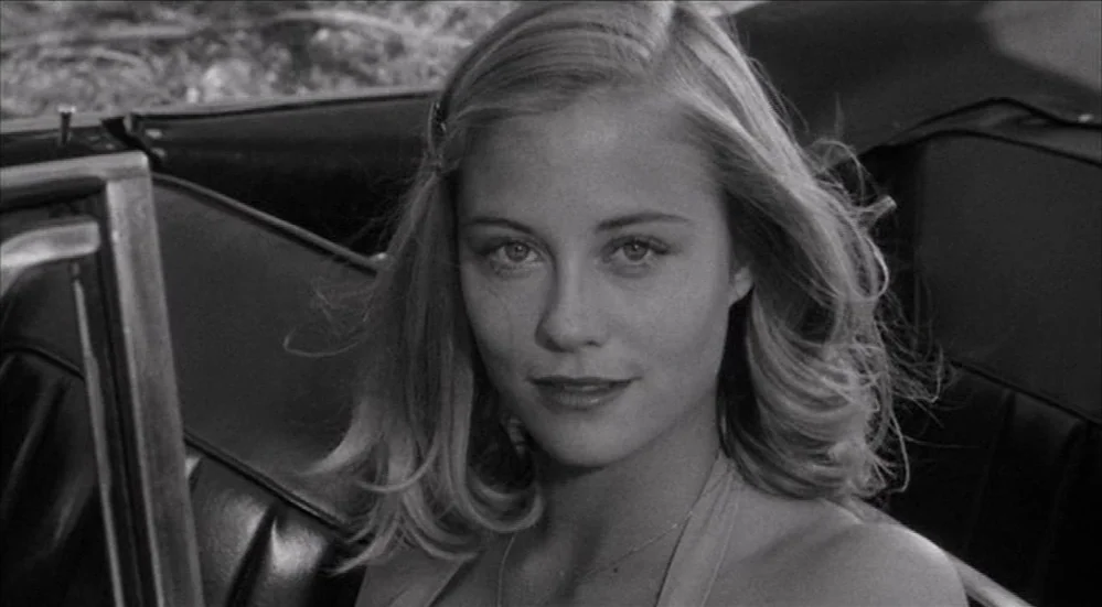 The Last Picture Show (1971) movie still: closeup — A close view of a woman sitting in the front passenger seat of a car. The interior consists of…