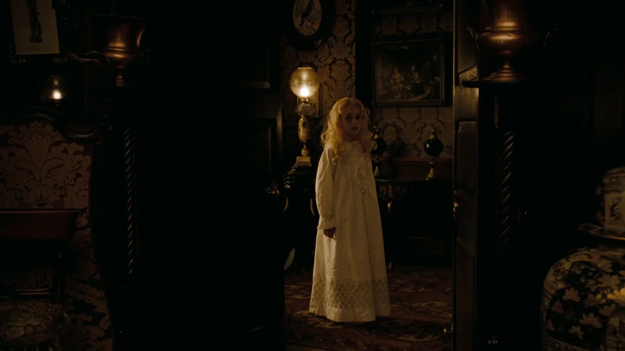 Alice in Wonderland (2010) movie still: fullbody — A dimly lit Victorian-style hallway features dark patterned wallpaper and heavy wooden doors. A…