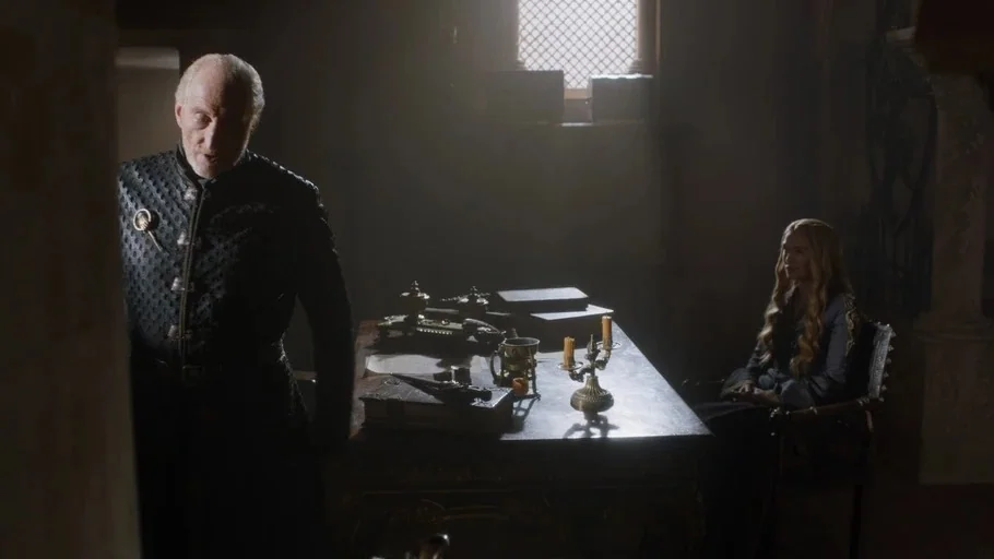 Game of Thrones: The Last Watch (2019) movie still: medium — A stone-walled study features a central dark wood desk piled with books and items. An…