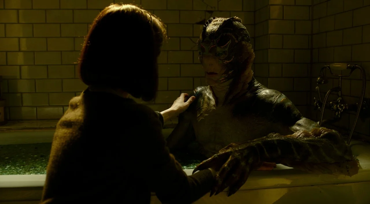 The Shape of Water (2017) movie still: medium — A tiled room with a claw-foot bathtub filled with water holds an amphibious creature. A woman stands…
