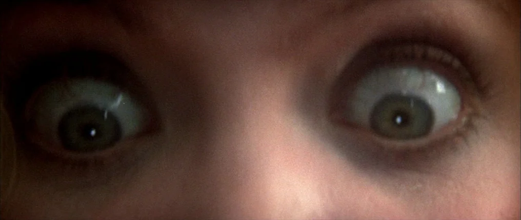 Dressed to Kill (1980) movie still: closeup — An extreme close-up of a pair of human eyes fills the entire frame. The subject is looking directly…
