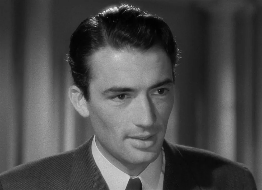 Spellbound (1945) movie still: closeup — A well-lit interior setting featuring vertical lines suggested by blurred background elements. A man in a…