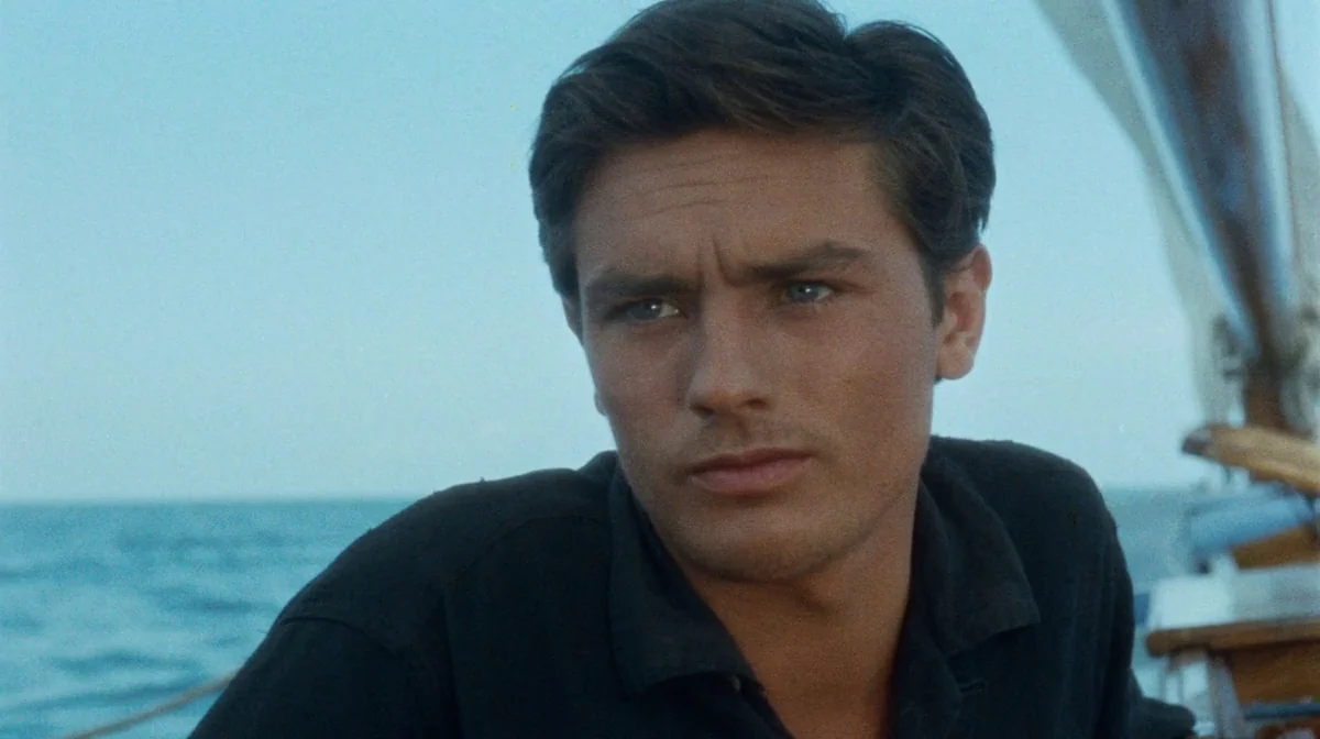 Purple Noon (Plein Soleil) (1960) movie still: medium — The deck of a sailboat set against an expansive blue ocean horizon. A young man sits in the…