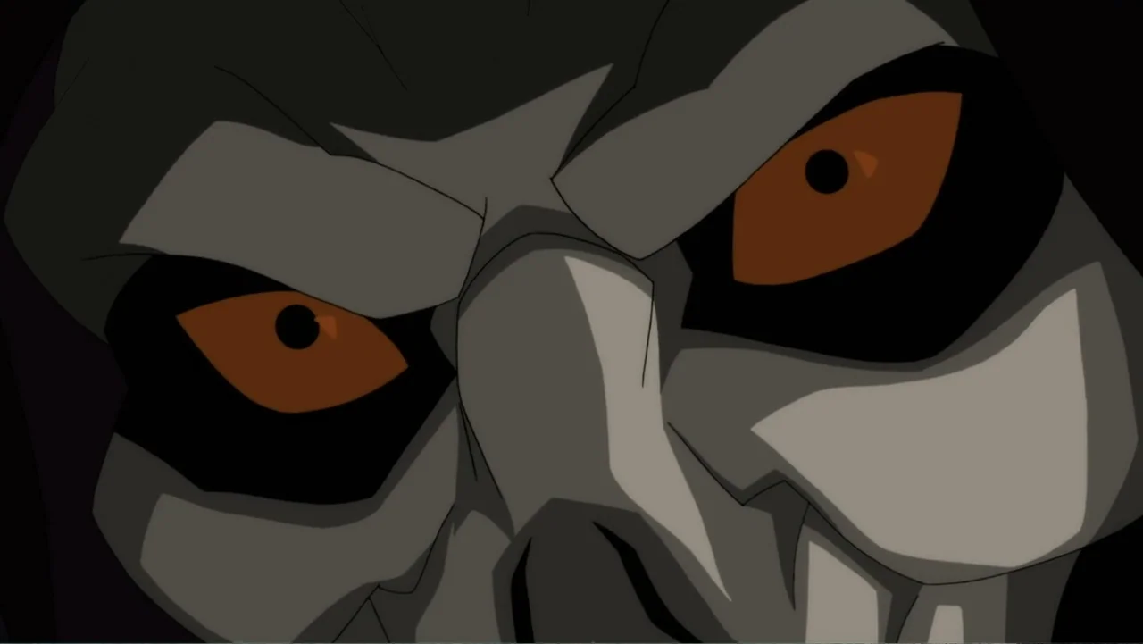Justice League Dark (2017) movie still: closeup — A close-up view of a pale, skeletal face emerging from a black, dark background. The character has…