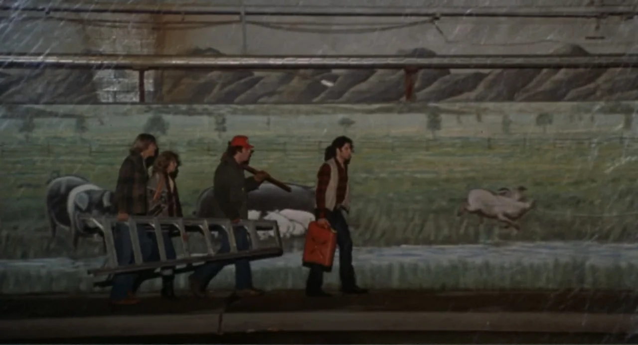 Carrie (1976) movie still: fullbody — A painted mural depicting farm animals spans the curved concrete wall of a tunnel. Four individuals walk past…