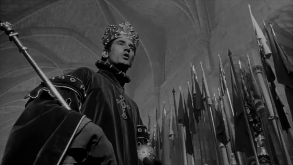 Falstaff (Chimes at Midnight) (1965) movie still: medium — A stone chamber features high vaulted ceilings and a collection of tall ceremonial flags.…