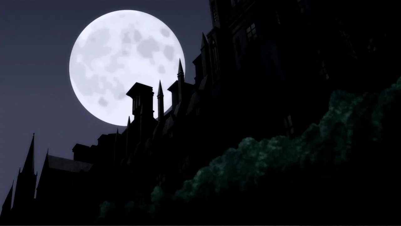 Batman: The Dark Knight Returns, Part 1 (2012) movie still: establishing — A dark gothic manor silhouette stands prominently against a large bright…