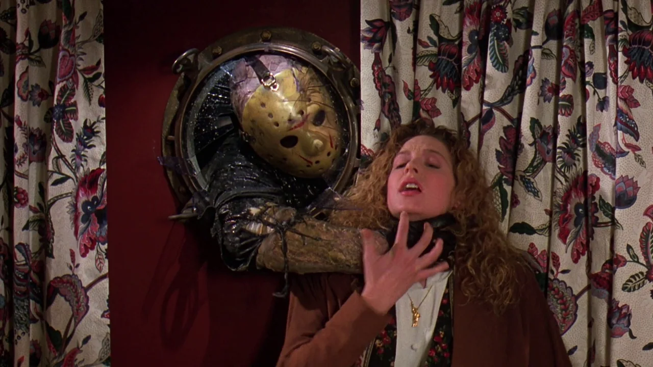 Friday the 13th Part VIII: Jason Takes Manhattan (1989) movie still: medium — A dark cabin interior features a circular metal porthole mounted on a…