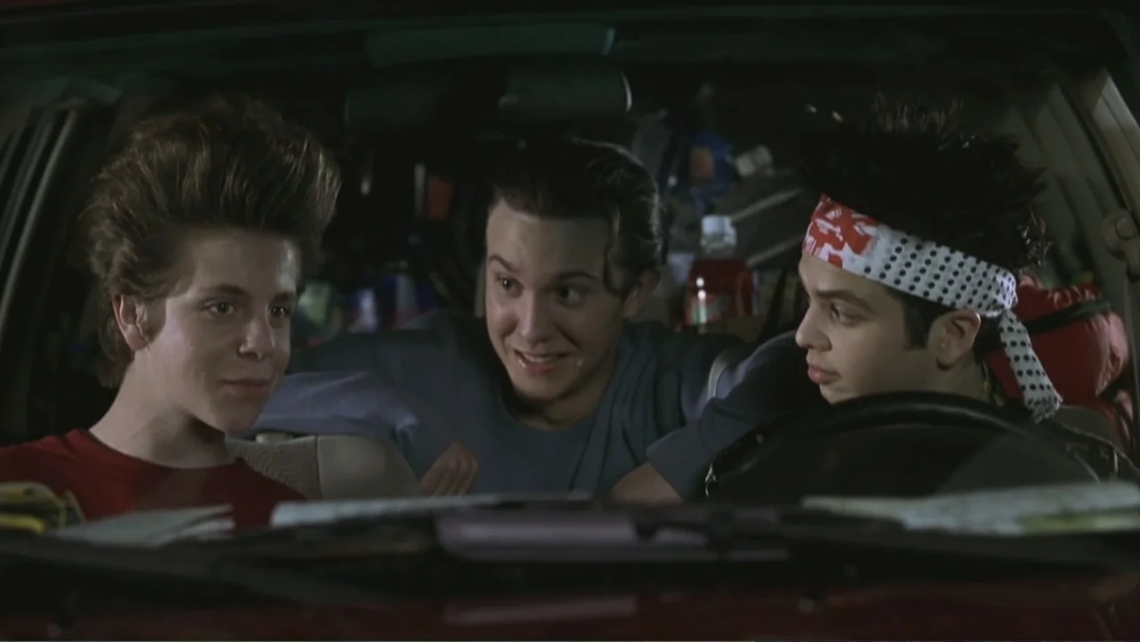 Not Another Teen Movie (2001) movie still: medium — Three teenage boys sit in the front and middle seats of a dark car. They are positioned close…