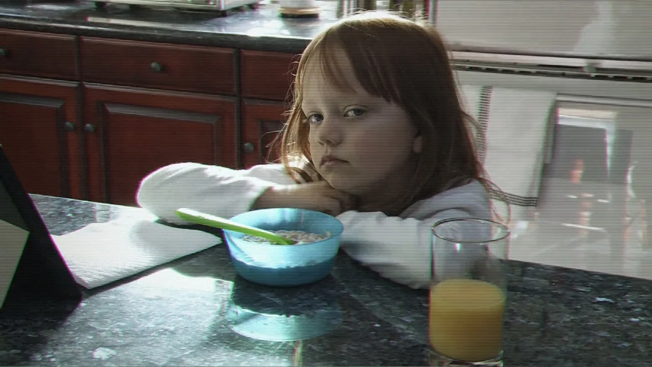 Paranormal Activity: The Ghost Dimension (2015) movie still: medium — A residential home counter features dark granite surfaces and wood cabinetry.…