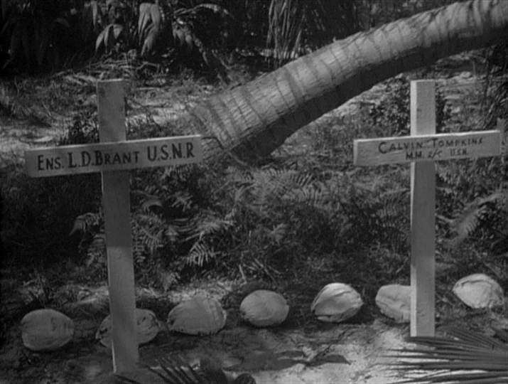 They Were Expendable (1945) movie still: medium — A sandy patch in a tropical environment contains two simple wooden crosses for graves. Coconuts…