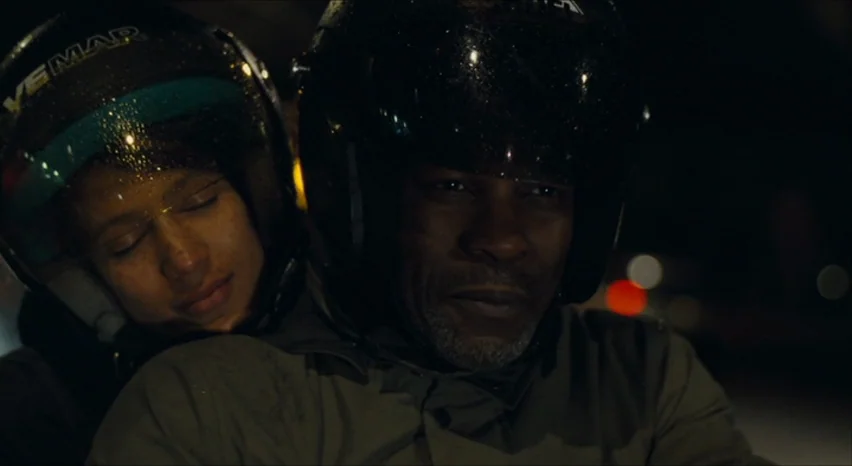 35 Shots of Rum (2008) movie still: medium — A man and a woman ride a motorcycle through a dark urban environment at night. The man navigates the…