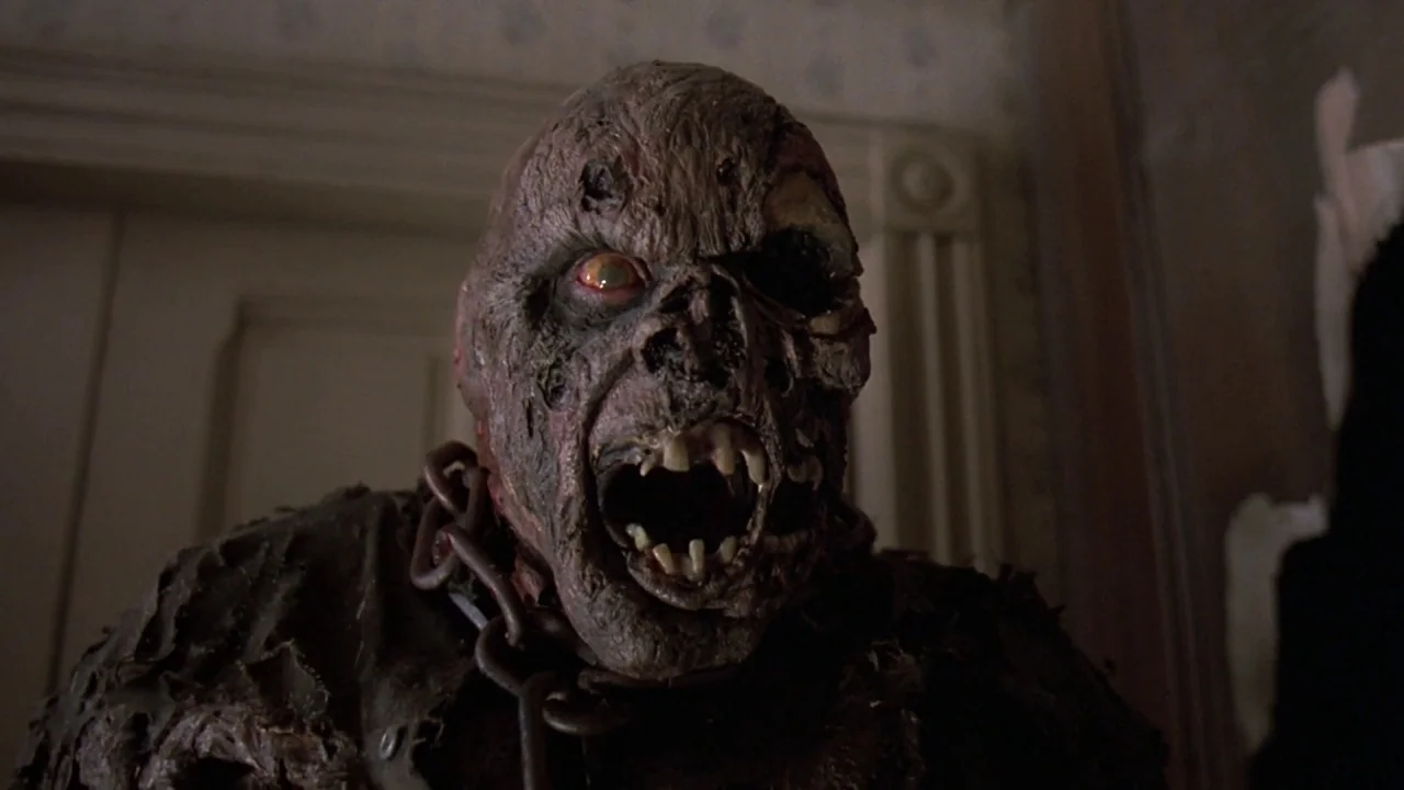 Friday the 13th Part VII: The New Blood (1988) movie still: closeup — A dimly lit interior space with peeling wallpaper visible in the background. A…