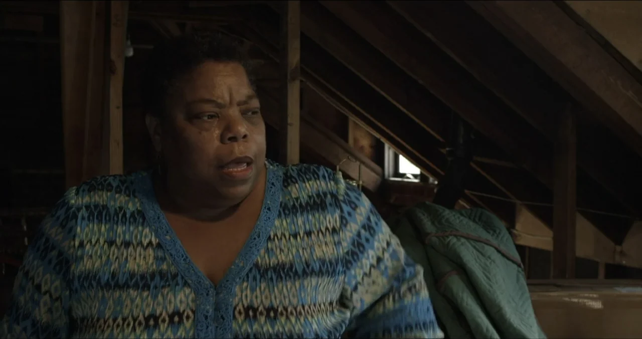 Faith, Love & Chocolate (2018) movie still: medium — An attic space with exposed wooden rafters and stored items in the background. A woman in a…