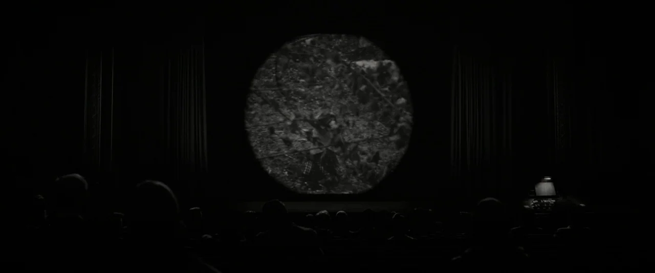 Wonderstruck (2017) movie still: wide — A dimly lit, vintage movie theater features a circular projection light hitting a central screen.…