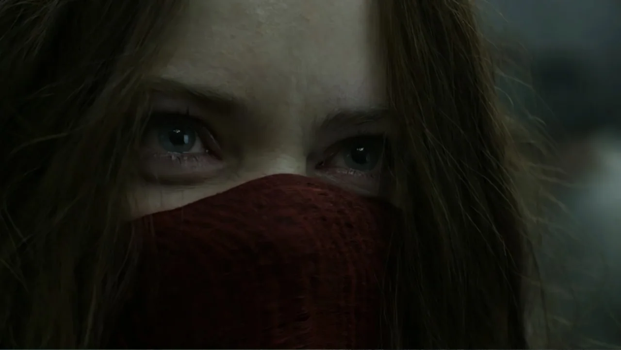 Mortal Engines (2018) movie still: closeup — A dimly lit, indistinct dark space surrounds a person with a face covering. The subject stares ahead…